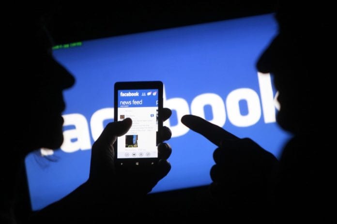 File of a smartphone user showing the Facebook application on his phone in Zenica